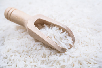 A Wooden Kitchen Scoop On A Pile Of Rice