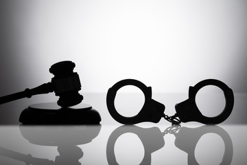 Handcuff Near Gavel With Sounding Block