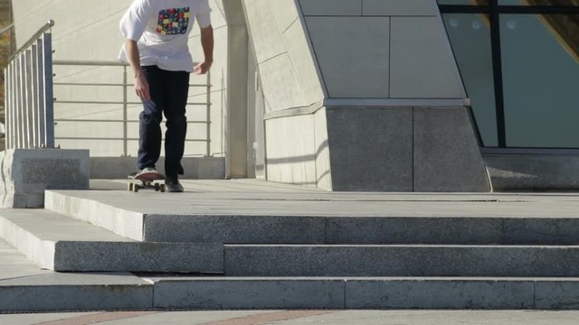 Skateboarder does trick firecracker from street stairs, 2x slowmotion