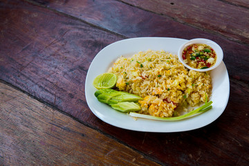 Crab meat fried rice, Khao Pad Poo. Thai famous street food. Thai recommend menu for tourist. fried rice with crab meat and egg, cucumber on side dish.