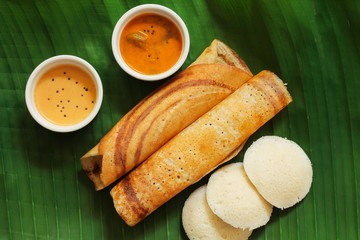 South Indian Vegetarian meal paper Masala Dosa chutney and sambar on Banana leaf