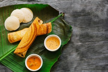 South Indian Vegetarian meal paper Masala Dosa chutney and sambar on Banana leaf