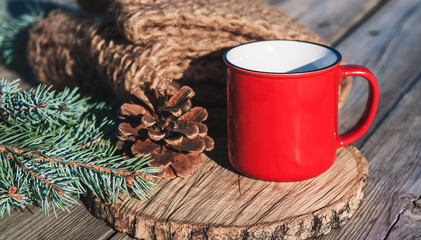 Red cup with a christmas decoration.
