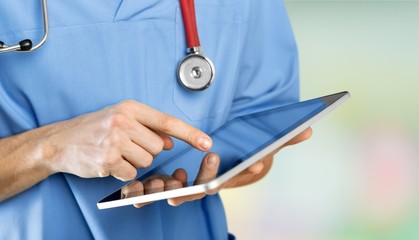 Doctor at hospital working with tablet