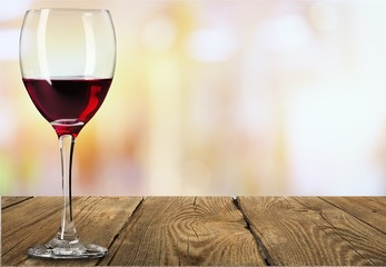 Red wine glass on wooden desk
