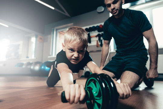 Sporty Child Is Doing Exercises With The Gym Wheel.