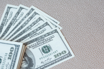 American dollar banknotes on leather sofa,