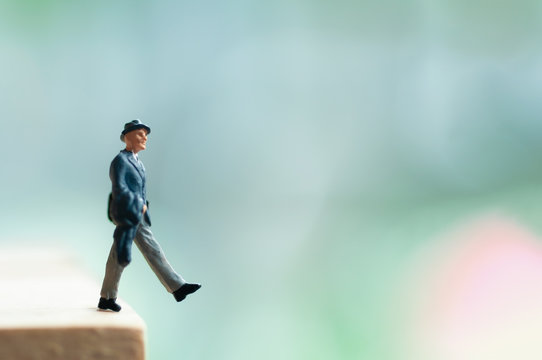 Selective focus miniature business people wearing hat looking to cloudy golden bitcoin investment, unaware with the exchange rate risk,  no investment information make people in risk.