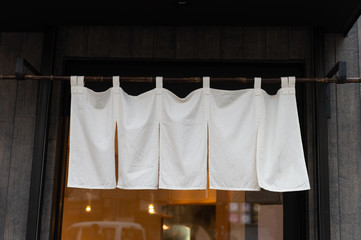 The curtain-like fabric that hangs in front of traditional Japanese restaurants and shops not only serves as a signboard, but holds a larger meaning,