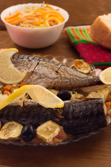 Grilled mackerel with vegetables and lemon.