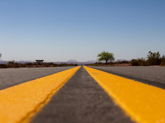 View from the ground of a route. The double yellow line is lost on the horizon.