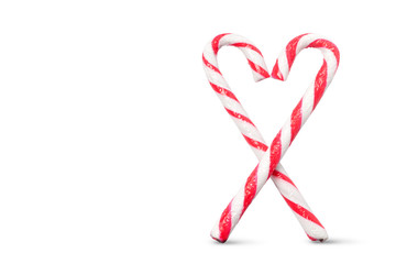 Candy Canes arranged in a heart shape isolated on white background
