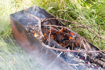 Wood burning in a barbeque grill. Closeup of firewood