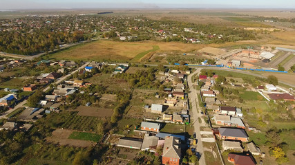 Top view of the village. The village of Poltavskaya. Top view of the village. One can see the roofs of the houses and gardens. Village bird eye view.