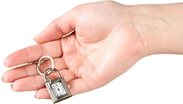 Hand Holding Keychain Lock With Clock And Key - Isolated