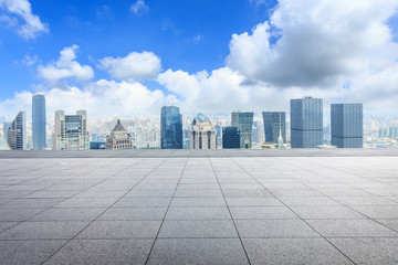 Panoramic Shanghai skyline and buildings with empty concrete square floor
