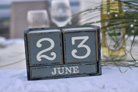 Wood blocks in box with date, day and month 23 June. Wooden blocks calendar