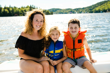 Fototapeta na wymiar Family out boating together having fun on vacancy