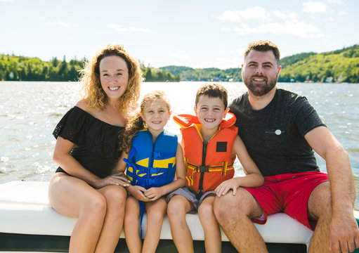 Family Out Boating Together Having Fun On Vacancy