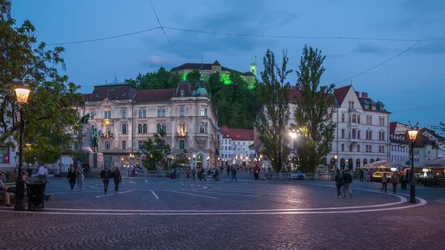 Presern square, important squre and a major meeting point in Ljubljana, Slovenia. Day to night video, city lights switch on.