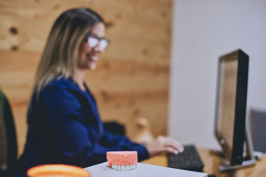 Defocused Image Of Receptionist Working In Dental Office