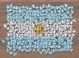 Flag of the Argentina in disorganized pieces of a puzzle.