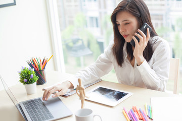 Protrait of Beautiful businesswoman sitting at desk and working with laptop computer.