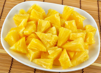 Sliced pineapple on wooden table