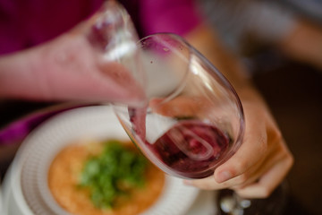 wine being pouring into a glass closeup