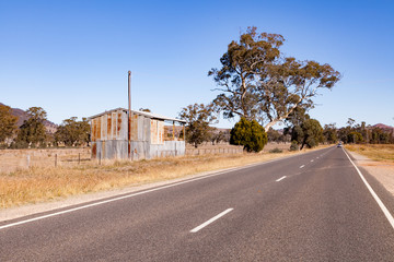 Outback Australia and its dry interia landscape full of relics bone fossils and motor bikesl