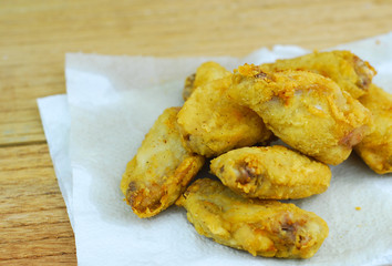 Crispy fried chicken on wooden background