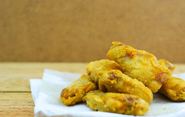 Crispy fried chicken on wooden background