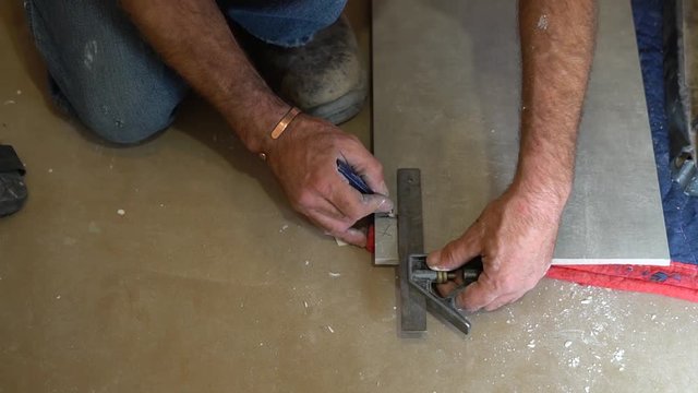 Package shots of Carpenter measuring ceramic with traditional T Square pencil marks & high powered electric saw