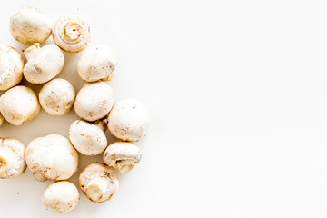 Mushroom champignons. Fresh raw whole champignons on white background top view copy space