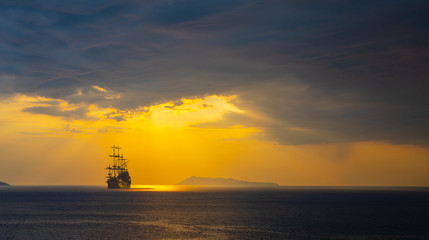 Old ship silhouette in sunset scenery, Italy