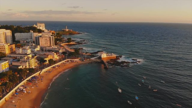 Aerial view of Salvador, Bahia, Brazil, tilt up from Farol da Barra lighthouse to Salvador cityscape