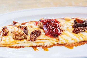 Typical dessert of the Canary Islands, Spain. Roasted cheese with jam, honey, nuts and dehydrated fruits.