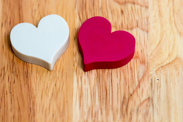 white and red couple hearts on wooden texture background. symbol of love and valentines day. vintage style. can be use to greeting card and background for special event.