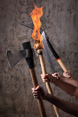Angry mob holding pitchfors,machetes,axes, and flaming torches