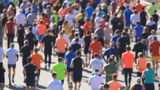 Running people in blurred of city marathon 