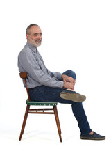 portrait of middle aged man sitting  on white