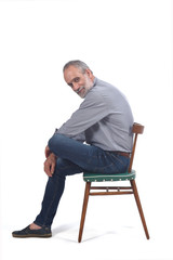 portrait of middle aged man sitting  on white