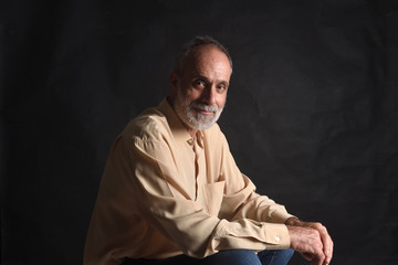 portrait of a middle aged man on black