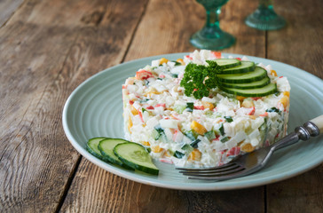 Salad with crab sticks, vegetables, rice and eggs