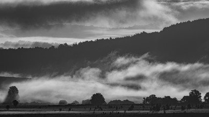 Foggy sunrise in the country, dark colors