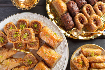 baklava with pistachio. turkish traditional delight on a dark wood background