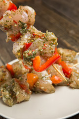 skewers of raw meat and vegetables