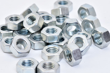 Fasteners on a white background. Manufacture of metal products.