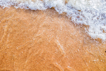 Ocean wave on sand background for creative