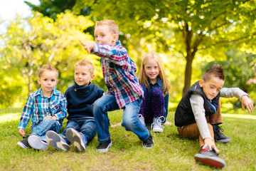 Fototapeta premium A group of children in spring field having fun